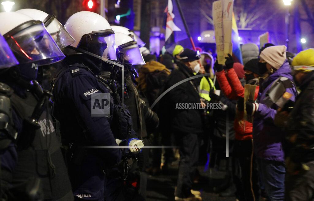 Czarek Sokolowski Protester face police during a protest against a new anti-abortion law in Warsaw, Poland, Thursday, Jan. 28, 2021. A near-total ban on abortion has taken effect in Poland three months after a top court ruled that the abortion of congenitally damaged fetuses is unconstitutional. Led by a women’s rights group, people poured onto the streets of Warsaw and other cities for the second evening in a row on Thursday to protest the move. (AP Photo/Czarek Sokolowski)