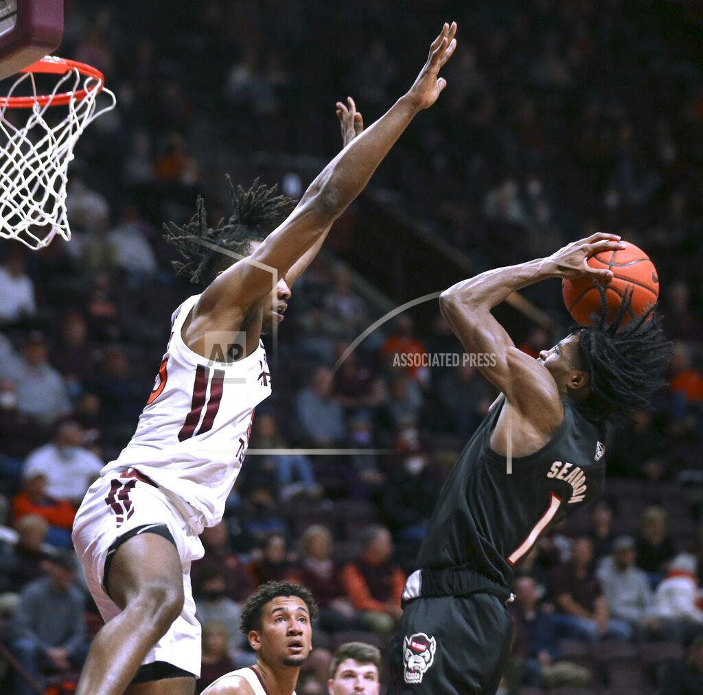 Matt Gentry Virginia Tech's Justyn Mutts (25) defends against North Carolina State's Dereon Seabron (1) in the first half of an NCAA college basketball game Tuesday, Jan. 4, 2022, in Blacksburg, Va. (Matt Gentry/The Roanoke Times via AP)