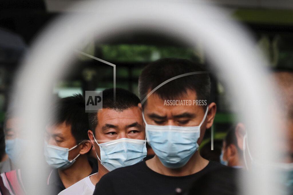 Andy Wong Commuters wearing protective face masks to help curb the spread of the new coronavirus line up to board a bus at a bus terminal in Beijing, Monday, June 22, 2020. A Beijing government spokesperson said the city has contained the momentum of a recent coronavirus outbreak that has infected a few hundreds of people, after the number of daily new cases fell to single digits. (AP Photo/Andy Wong)