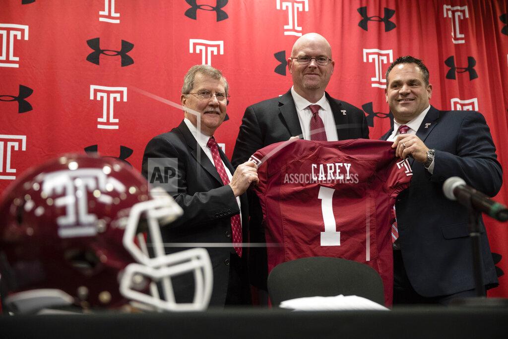 Temple University's President Richard Englert, left, and director of athletics, Patrick Kraft, right, pose for photographs with incoming head coach Rod Carey, center, speaks during an NCAA college football news conference in Philadelphia, Friday, Jan. 11, 2019. (AP Photo/Matt Rourke)