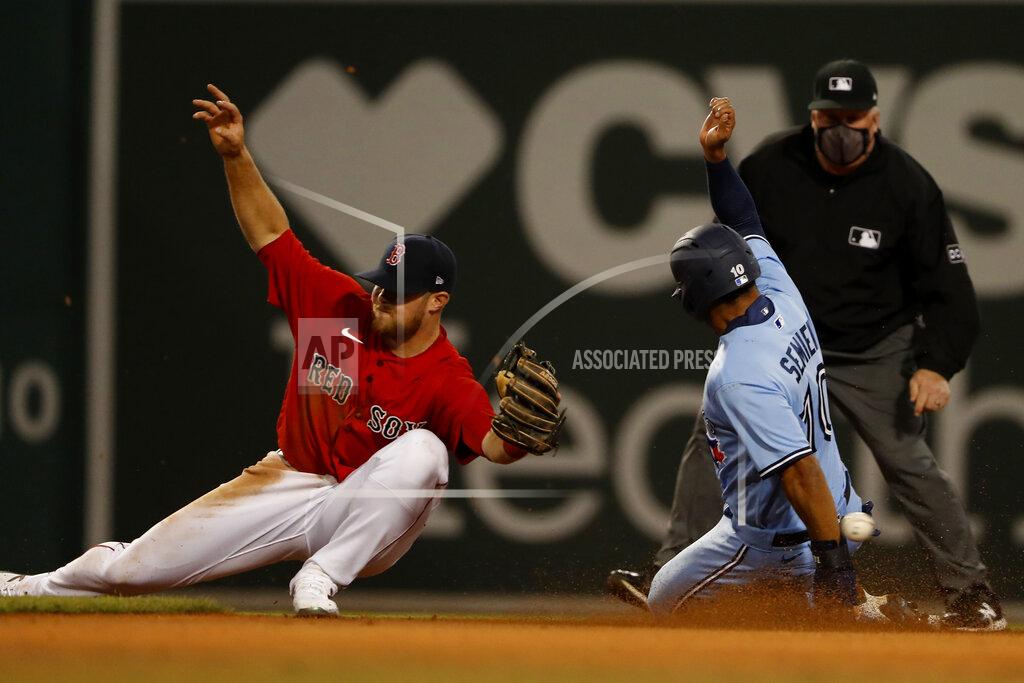 Winslow Townson Boston Red Sox third baseman Christian Arroyo can't handle the throw as Toronto Blue Jays' Marcus Semien steals second base during the eighth inning of a baseball game Tuesday, April 20, 2021, at Fenway Park in Boston. (AP Photo/Winslow Townson)