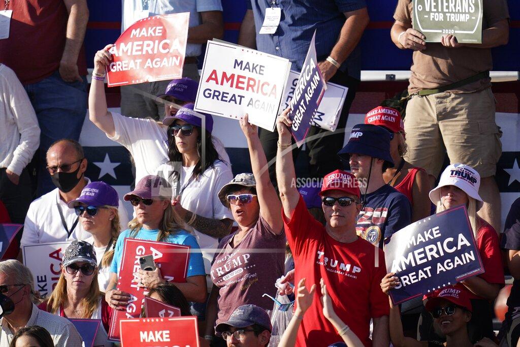 Supporters cheers as President Donald Trump speaks at a campaign rally Monday, Oct. 19, 2020, in Tucson, Ariz. (AP Photo/Ross D. Franklin)