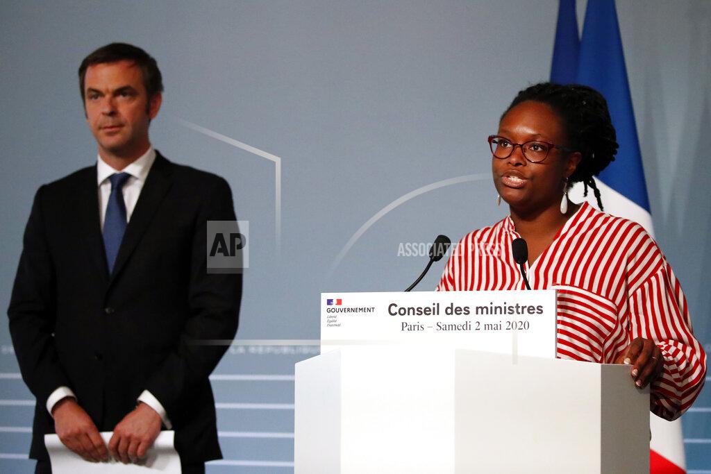 FILE - In this May 2, 2020 file photo, French Health Minister Olivier Veran, left, and French Government's spokesperson Sibeth Ndiaye attend a press conference after the cabinet meeting at the Elysee Palace, in Paris. French police searched the homes of the former prime minister, the current and former health ministers and other top officials Thursday in an investigation into the government response to the global coronavirus pandemic. Among those whose homes were searched include former Prime Minister Edouard Philippe, Veran, his predecessor Agnes Buzyn, top health official Jerome Salomon, and Sibeth Ndiaye, former government spokeswoman. (AP Photo/Francois Mori, Pool, File)