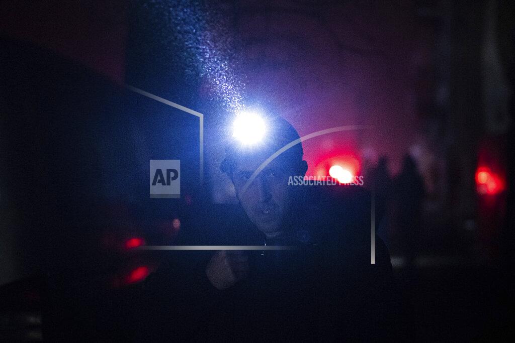 Evgeniy Maloletka A man walks at the city center which lost electrical power after yesterday's Russian rocket attack in Kyiv, Ukraine, Thursday, Nov. 24, 2022. (AP Photo/Evgeniy Maloletka)