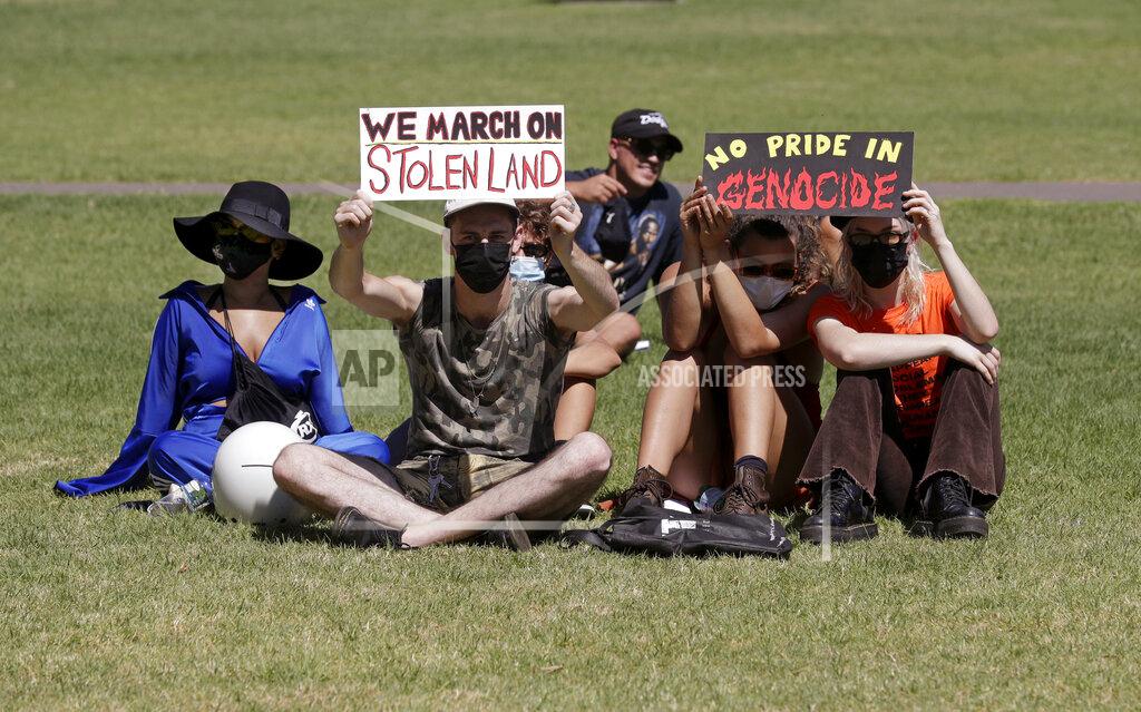 Rick Rycroft Protesters hold signs in a social distanced crowd during an Aboriginal-lead Invasion Day rally on Australia Day in Sydney, Tuesday, Jan. 26, 2021. Many of Australia's First Nations people say that sovereignty has never been ceded and oppose ongoing colonial violence and destruction. (AP Photo/Rick Rycroft)