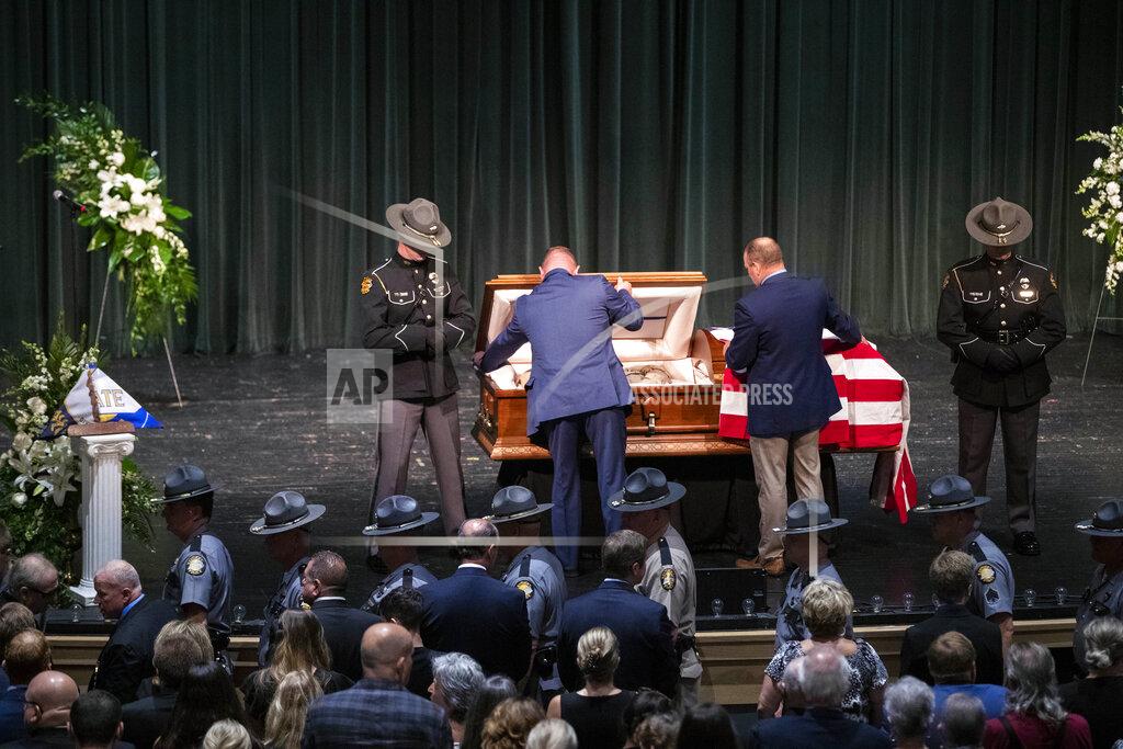 Silas Walker Officers close the casket for Floyd County Deputy William Petry at the Mountain Arts Center in Prestonsburg, Ky., Tuesday, July 5, 2022. Dep. Petry was killed when a man with a rifle opened fire on police attempting to serve a warrant Thursday, June 30. (Silas Walker/Lexington Herald-Leader via AP)
