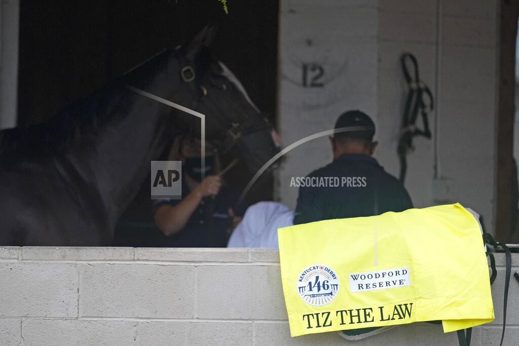 Darron Cummings Kentucky Derby entry Tiz the Law is walked back to a stall following a workout at Churchill Downs, Wednesday, Sept. 2, 2020, in Louisville, Ky. The 146th running of the Kentucky Derby is scheduled for Saturday, Sept. 5th. (AP Photo/Darron Cummings)