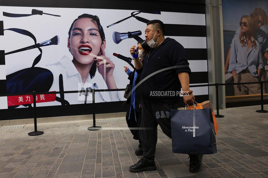 Ng Han Guan FILE - In this April 15, 2021, file photo, shoppers visit a retail district in Beijing. Developing Asian economies will grow at a solid 7.3% pace this year after contracting slightly in 2020 due to the pandemic, the Asian Development Bank says in its latest regional outlook. (AP Photo/Ng Han Guan, File)