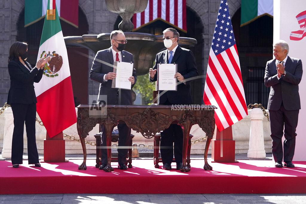Jacquelyn Martin FILE - In this June 8, 2021 file photo, John Creamer, Chargé d'Affaires U.S. Embassy, left center, and Mexico's Foreign Minister Marcelo Ebrard, hold up signed documents as Vice President Kamala Harris, left, and Mexican President Andres Manuel Lopez Obrador, applaud at a signing ceremony at the National Palace in Mexico City. A gathering of leaders from Latin America and the Caribbean in Mexico City on Saturday, Sept. 17, 2021, s the latest sign of Mexico flexing its diplomatic muscle as it looks to assert itself as the new mediator between the region and the United States. (AP Photo/Jacquelyn Martin, File)
