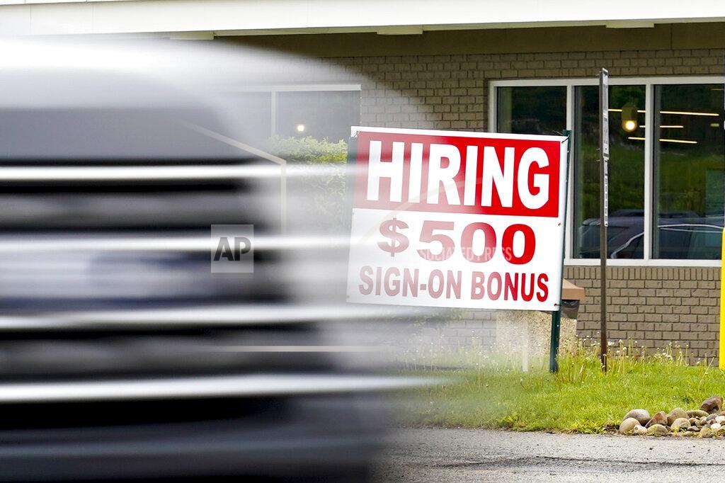 Keith Srakocic FILE—In this file photo from May 5, 2021, a vehicle speeds by a hiring sign offering a $500 bonus outside a McDonalds restaurant, in Cranberry Township, Butler County, Pa. Pennsylvania will resume work search requirements in July for hundreds of thousands of people receiving unemployment compensation, a top Wolf administration official said Monday, May 24, 2021. (AP Photo/Keith Srakocic, File)