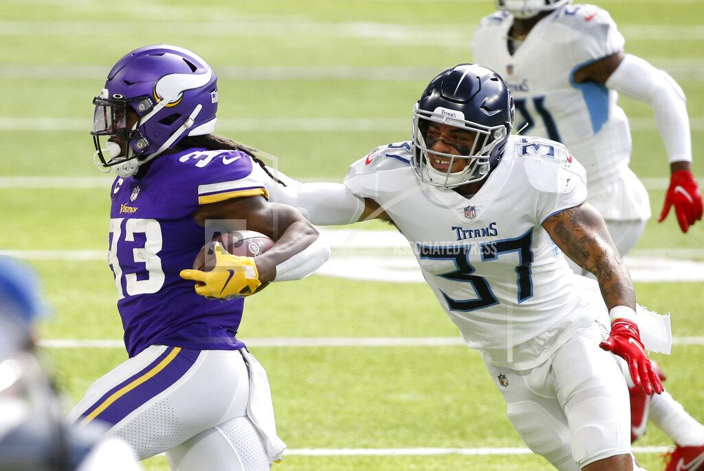 Bruce Kluckhohn Minnesota Vikings running back Dalvin Cook (33) tries to break a tackle by Tennessee Titans safety Amani Hooker (37) during the first half of an NFL football game, Sunday, Sept. 27, 2020, in Minneapolis. (AP Photo/Bruce Kluckhohn)
