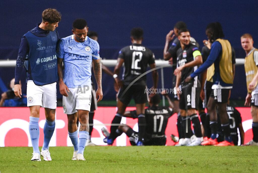 Franck Fife Manchester City's Gabriel Jesus is consoled by teammate John Stones, left, after their loss in the Champions League quarterfinal match against Lyon at the Jose Alvalade stadium in Lisbon, Portugal, Saturday, Aug. 15, 2020. (Franck Fife/Pool Photo via AP)