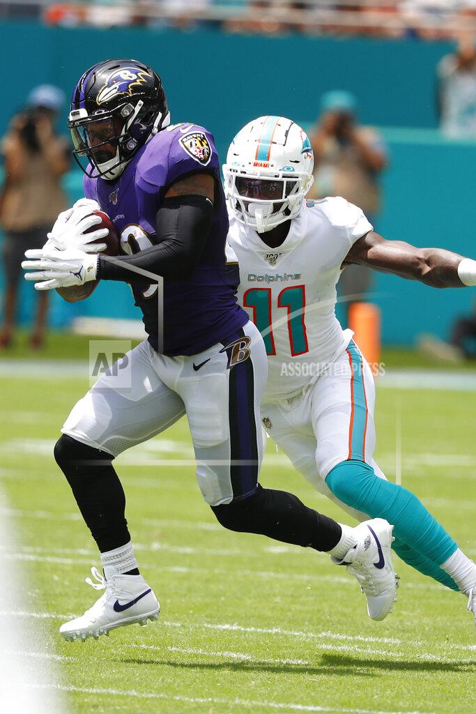 Wilfredo Lee Baltimore Ravens free safety Earl Thomas (29) intercepts a pass, as Miami Dolphins wide receiver DeVante Parker (11), attempts to tackle, during the first half at an NFL football game, Sunday, Sept. 8, 2019, in Miami Gardens, Fla. (AP Photo/Wilfredo Lee)