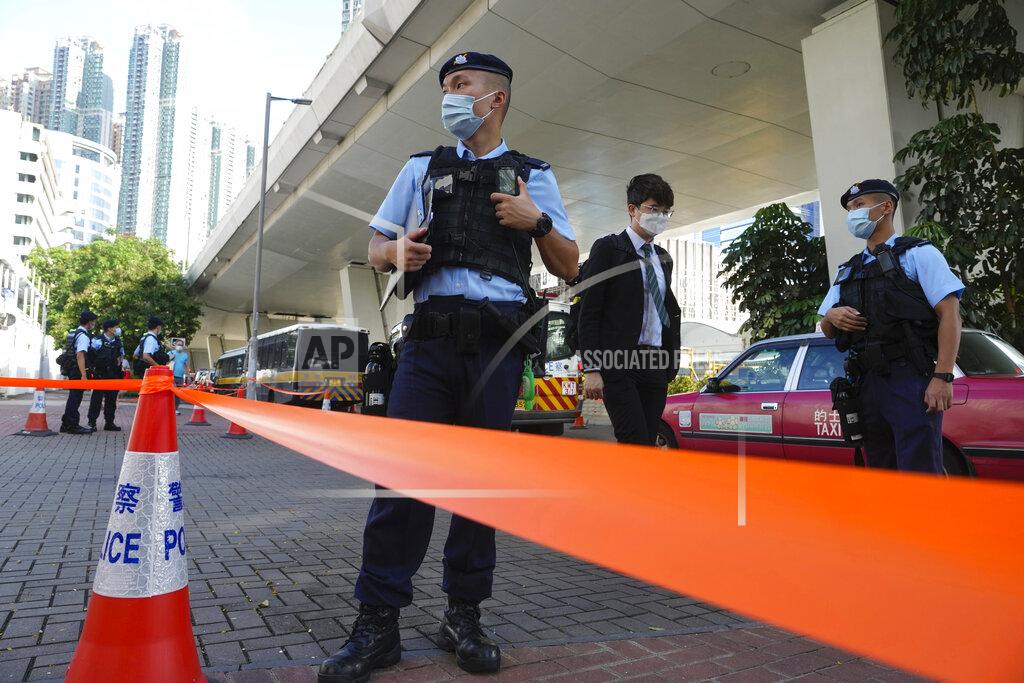 Vincent Yu Police officers stand guard outside local court in Hong Kong Thursday, July 22, 2021. Hong Kong police charged two top editors and two editorial writers at Apple Daily with collusion weeks after the city's largest pro-democracy newspaper was forced to cease publication and its assets were frozen. All four were charged with conspiring to "collude with a foreign country or with external elements to endanger national security" under the city's year-old national security law and appeared in court Thursday. (AP Photo/Vincent Yu)