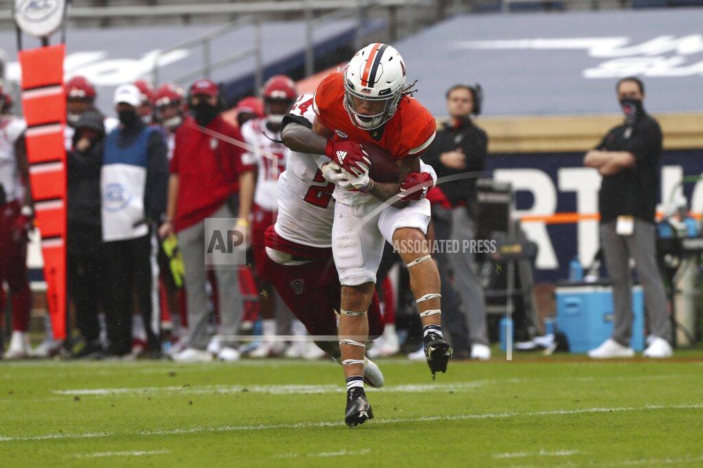 Erin Edgerton North Carolina State's Christopher Scott Jr. (24) tackles Virginia running back Billy Kemp IV (4) during an NCAA college football game, Saturday, Oct. 10, 2020, at Scott Stadium in Charlottesville, Va. (Erin Edgerton/The Daily Progress via AP)