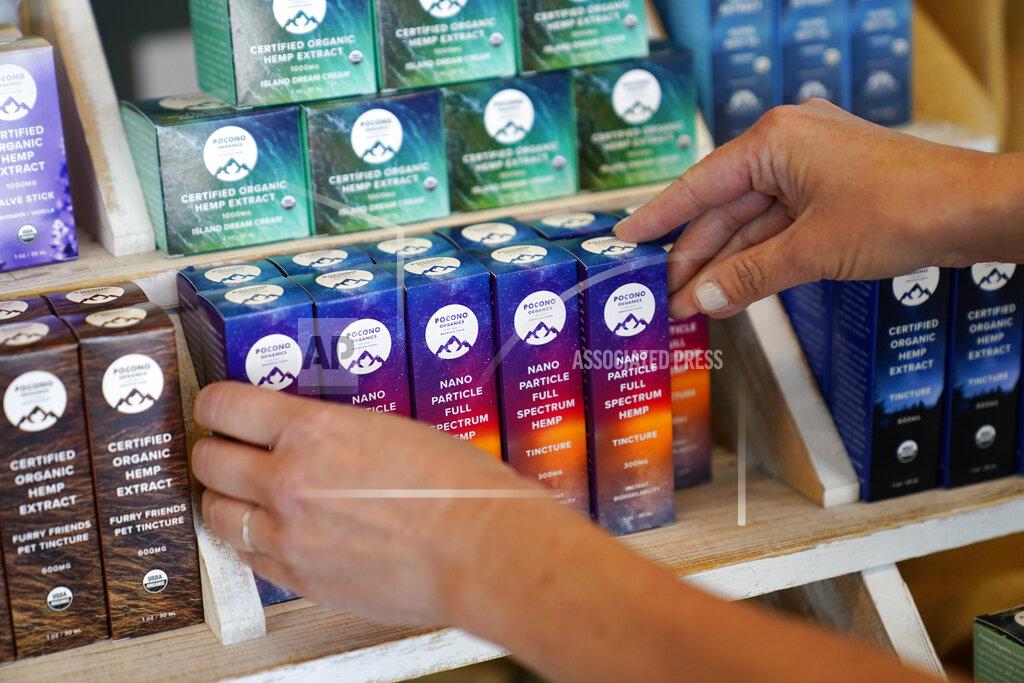 Matt Slocum Ashley Walsh, founder of Pocono Organics farm, arranges CBD products for sale at the farm adjacent to Pocono Raceway, Friday, June 25, 2021, in Long Pond, Pa. The 380 acre farm is the title sponsor for Saturday's NASCAR auto race, The Pocono Organics CBD 325, the first Cup race with a CBD sponsorship. (AP Photo/Matt Slocum)