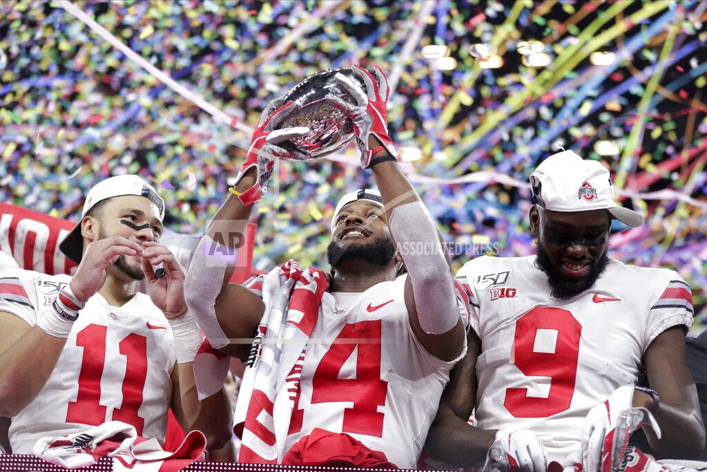 Michael Conroy Ohio State wide receiver K.J. Hill (14) holds the trophy following the team's 34=21 win over Wisconsin in the Big Ten championship NCAA college football game, early Sunday, Dec. 8, 2019, in Indianapolis. (AP Photo/Michael Conroy)