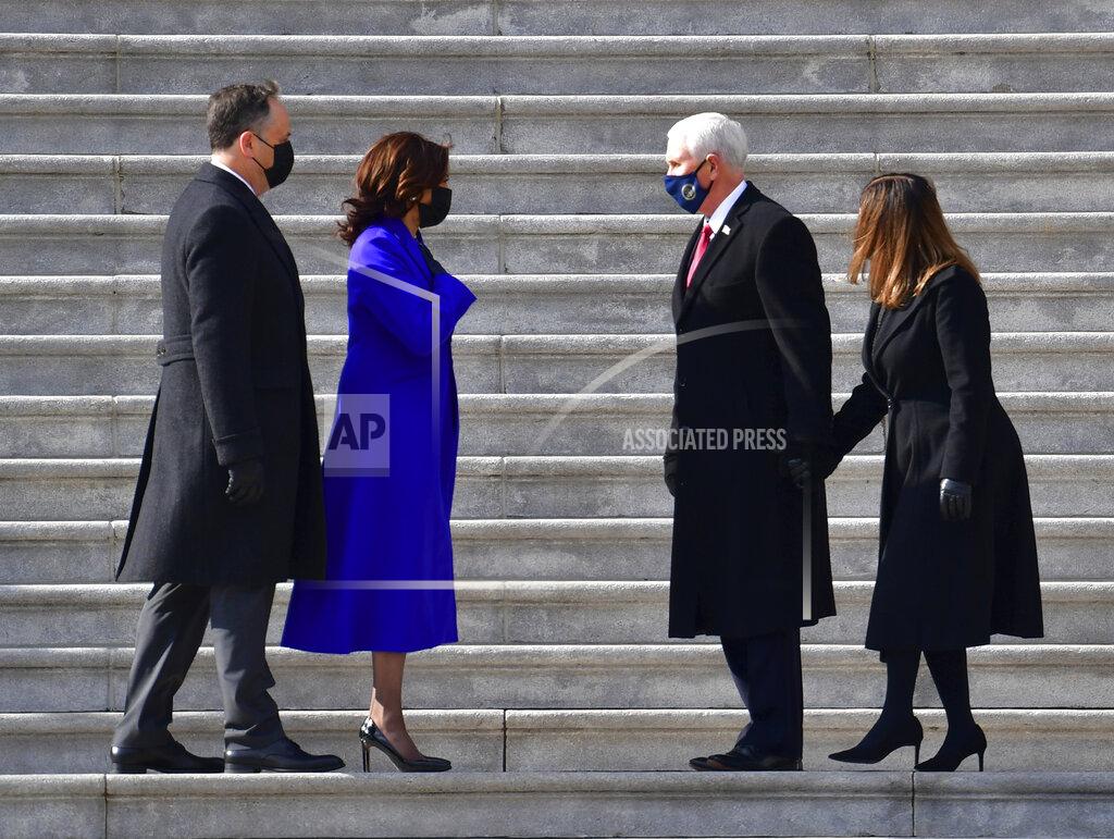 David Tulis Vice President Kamala Harris and husband Douglas Emhoff exchange words with former Vice President Mike Pence and wife Karen Pence on the east side steps of the U.S. Capitol after the 59th Presidential Inauguration in Washington on Wednesday, Jan. 20, 2021. (David Tulis/Pool Photo via AP)