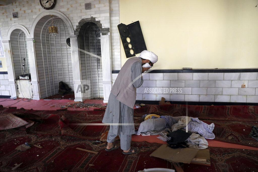 Rahmat Gul A Religious student cry inside a mosque after a bomb explosion in Shakar Dara district of Kabul, Afghanistan, Friday, May 14, 2021. A bomb ripped through a mosque in northern Kabul during Friday prayers killing 12 worshippers, Afghan police said. (AP Photo/Rahmat Gul)