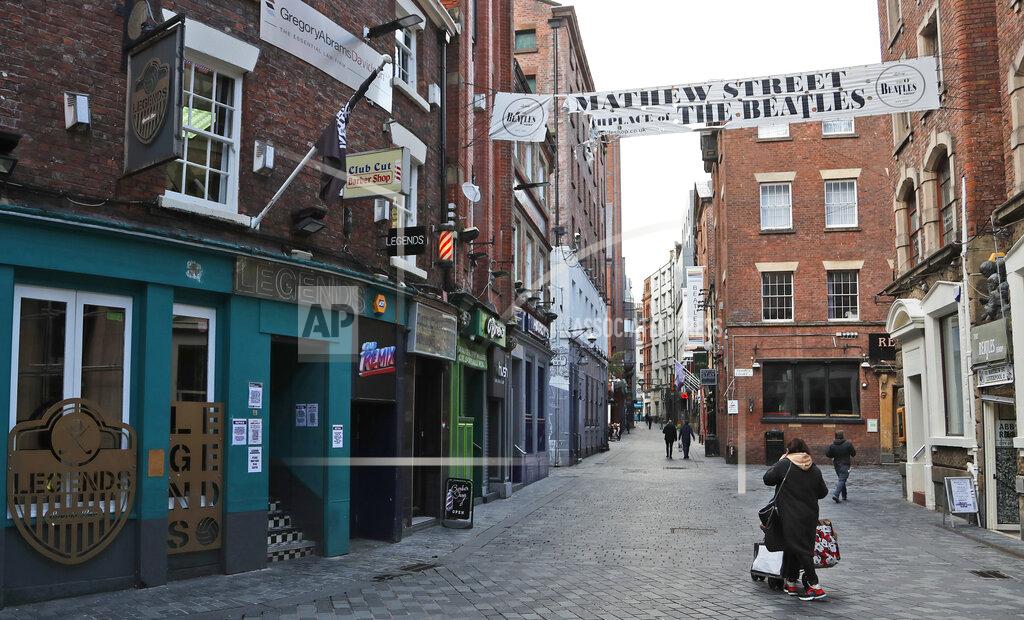 Frank Augstein Bars and pubs are shut as new anti-coronavirus measures are set to come into force in Liverpool, England, Wednesday, Oct. 14, 2020. Liverpool, the English port city that gave the world the Beatles, weathered decades of industrial decline before becoming a celebrated symbol of urban renewal. Now, the coronavirus is putting the city's hard-won revival in jeopardy, and raising tensions between the north of England and the wealthier south. (AP Photo/Frank Augstein)