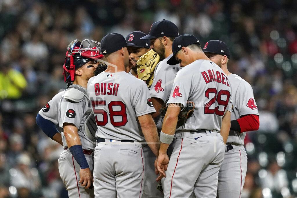 Charles Rex Arbogast Boston Red Sox pitching coach Dave Bush (58) talks with starting pitcher Michael Wacha, center, during the third inning of the team's baseball game against the Chicago White Sox on Thursday, May 26, 2022, in Chicago. (AP Photo/Charles Rex Arbogast)