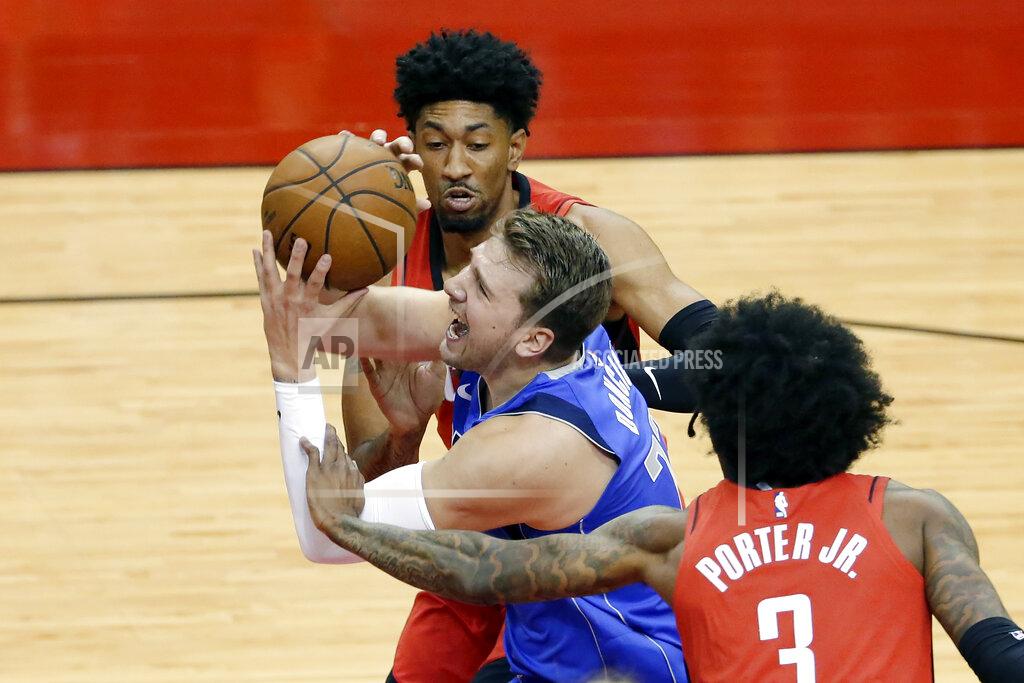 Michael Wyke Dallas Mavericks guard Luka Doncic (77) is fouled as he drives to the basket between during the first half of an NBA basketball game Wednesday, April 7, 2021, in Houston. (AP Photo/Michael Wyke, Pool)