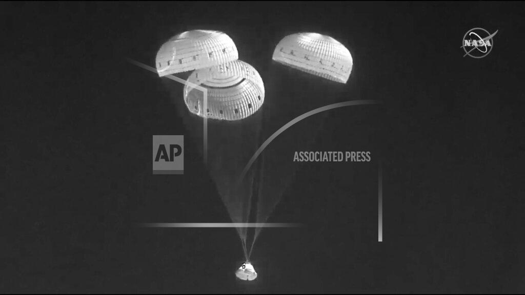 Uncredited In this infrared image from video made available by NASA, the Boeing Starliner capsule uses parachutes as it descends to land at the White Sands Missile Range in New Mexico on Wednesday, May 25, 2022. (NASA via AP)
