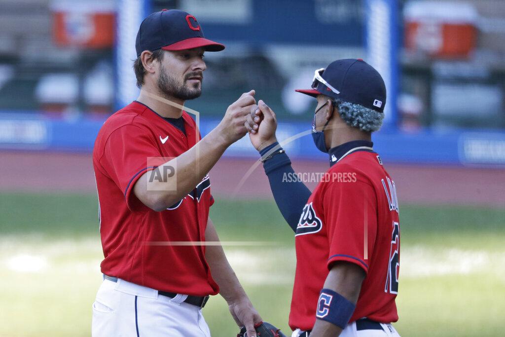 Tony Dejak Cleveland Indians relief pitcher Brad Hand, left, is congratulated by Francisco Lindor after the Indians defeated the Chicago White Sox 4-3 in the first baseball game of a doubleheader, Tuesday, July 28, 2020, in Cleveland. (AP Photo/Tony Dejak)