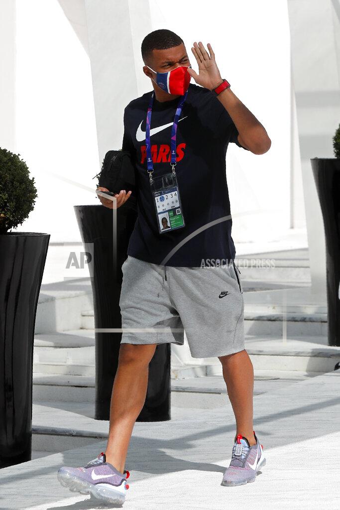 Armando Franca PSG's Kylian Mbappe gestures to fans as he leaves the team hotel for a training session in Lisbon, Friday Aug. 21, 2020. PSG will play Bayern in the Champions League final on Sunday. (AP Photo/Armando Franca)