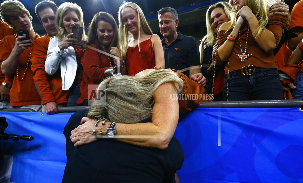 Butch Dill Texas quarterback Sam Ehlinger hugs his mother, Jena Ehlinger, after Texas defeated Georgia 28-21 in the Sugar Bowl NCAA college football game in New Orleans, Tuesday, Jan. 1, 2019. (AP Photo/Butch Dill)