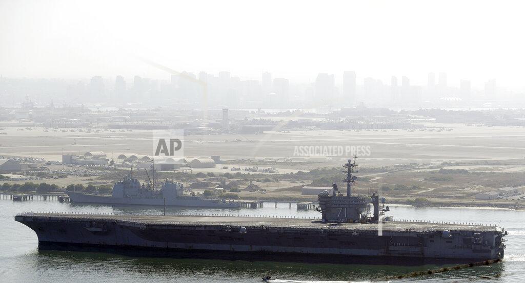 Gregory Bull FILE - In this July 9, 2020 file photo the USS Theodore Roosevelt aircraft carrier makes its way into San Diego Bay as seen from San Diego. Capt. Brett Crozier the dismissed captain of the U.S. Navy aircraft carrier knew he was jeopardizing his military career when he broke protocol and sent a now-famous email warning of possible sailor deaths due to a coronavirus breakout on board, but he did so in an urgent effort to help avoid a "larger catastrophe," he wrote in a witness statement obtained by the San Francisco Chronicle. (AP Photo/Gregory Bull, File)