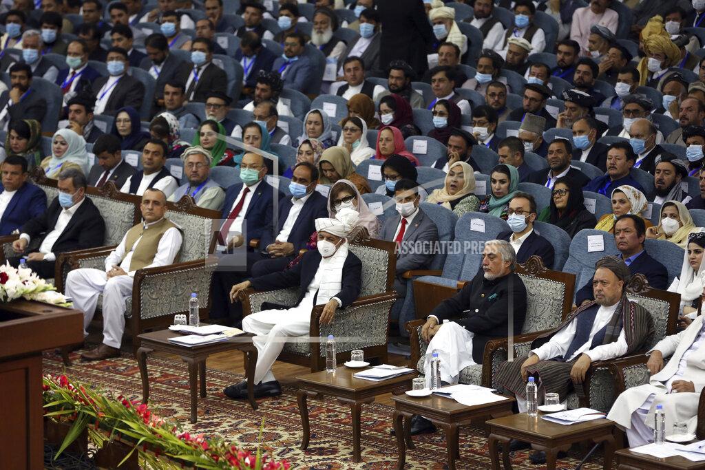 Rahmat Gul Afghan President Ashraf Ghani, center, wearing a protective face mask to help curb the spread of the coronavirus attends an Afghan Loya Jirga meeting in Kabul, Afghanistan, Friday, Aug. 7, 2020. The traditional council opened Friday in the Afghan capital to decide the release of a final 400 Taliban - the last hurdle to the start of negotiations between Kabul’s political leadership and the Taliban in keeping with a peace deal the United States signed with the insurgent movement in February. (AP Photo/Rahmat Gul)