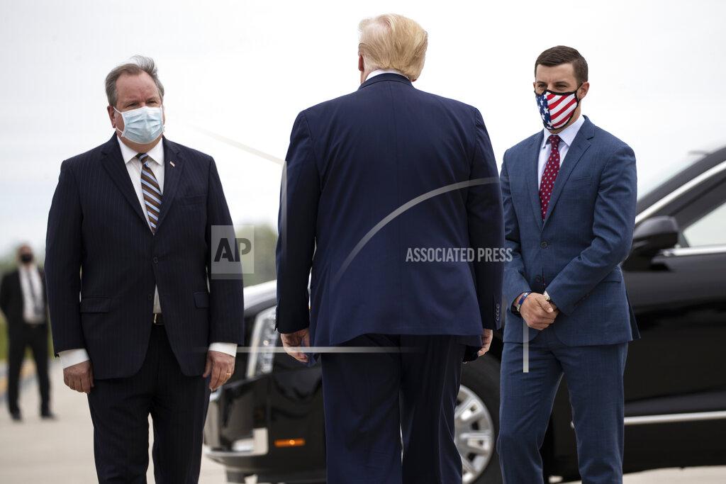 FILE - In this May 21, 2020, file photo, President Donald Trump is greeted by Kurt Heise, left, Supervisor of Plymouth Township, Mich., and Speaker Lee Chatfield, of the Michigan House of Representatives after stepping off Air Force One as he arrives at Detroit Metro Airport in Detroit. President Donald Trump summoned Michigan's Republican legislative leaders Chatfield and Senate Majority Leader Mike Shirkey, to the White House for a meeting Friday, Nov. 20, amid a GOP push to overturn the certification of Democrat Joe Biden's victory in the battleground state. (AP Photo/Alex Brandon, File)