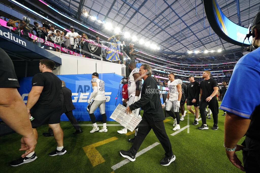 Ashley Landis Players for the Las Vegas Raiders leave the field due to a weather delay shortly before the scheduled start an NFL football game against the Los Angeles Chargers, Monday, Oct. 4, 2021, in Inglewood, Calif. (AP Photo/Ashley Landis)