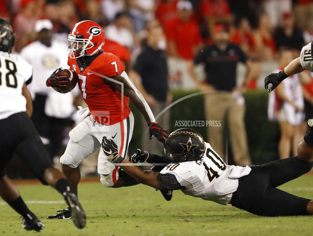 John Bazemore Georgia running back D'Andre Swift (7) tries to break away from Vanderbilt linebacker Jordan Griffin (40) during the second half of an NCAA college football game Saturday, Oct. 6, 2018, in Atlanta. (AP Photo/John Bazemore)
