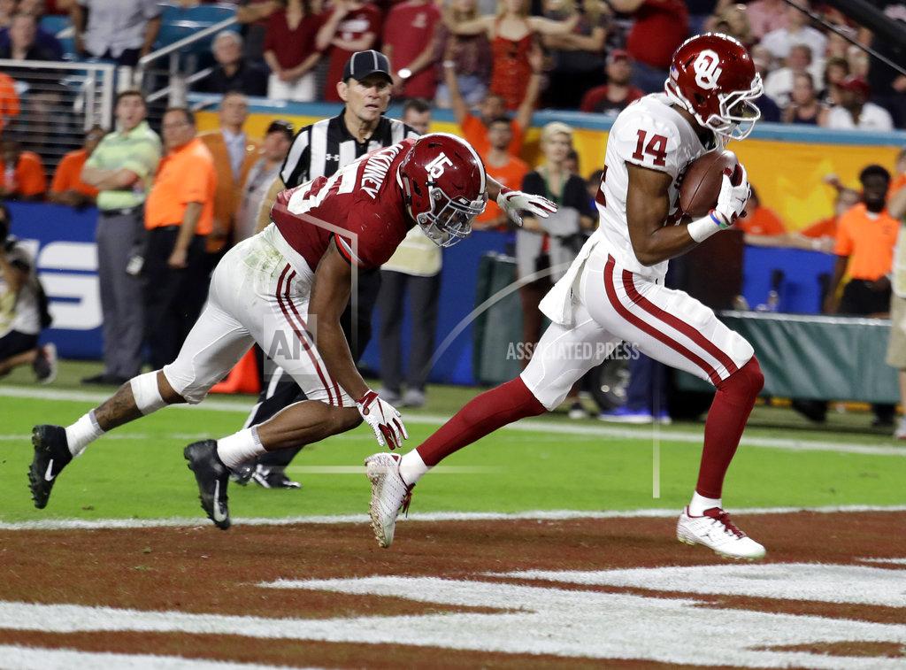 Lynne Sladky Oklahoma wide receiver Charleston Rambo (14) catches a pass for in the end zone for a touchdown ahead of Alabama defensive back Xavier McKinney (15), during the second half of the Orange Bowl NCAA college football game, Saturday, Dec. 29, 2018, in Miami Gardens, Fla. (AP Photo/Lynne Sladky)