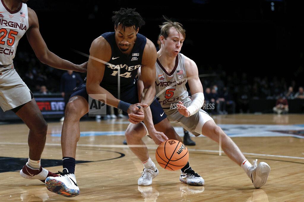 Adam Hunger Virginia Tech's Storm Murphy (5) steals the ball from Xavier's Ben Stanley (14) during the first half of an NCAA college basketball game in the NIT Season Tip-Off tournament Friday, Nov. 26, 2021, in New York. (AP Photo/Adam Hunger)