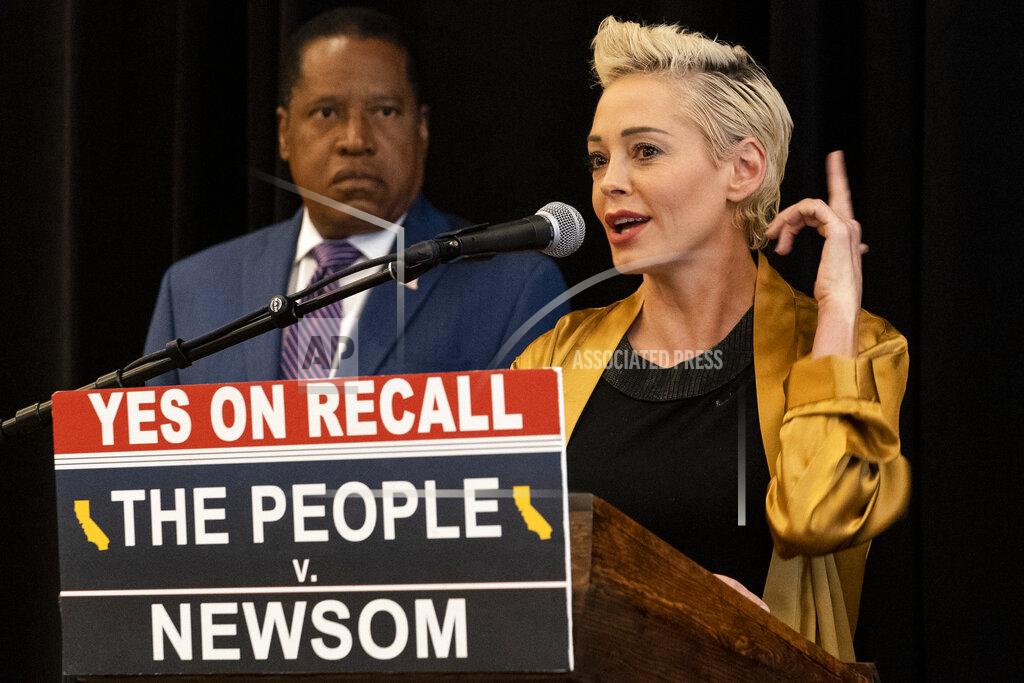 Damian Dovarganes Republican conservative radio talk show host Larry Elder, left, listens as former actress and activist Rose McGowan speaks during as the pair hold a news conference at the Luxe Hotel Sunset Boulevard in Los Angeles Sunday, Sept. 12, 2021. Elder is running to replace Democratic Gov. Gavin Newsom in the Sept. 14 recall election. McGowan, who is known for her role in the "Scream" movie franchise, was one of the earliest of dozens of women to accuse Hollywood producer Harvey Weinstein of sexual misconduct, making her a major figure in the #MeToo movement. (AP Photo/Damian Dovarganes)