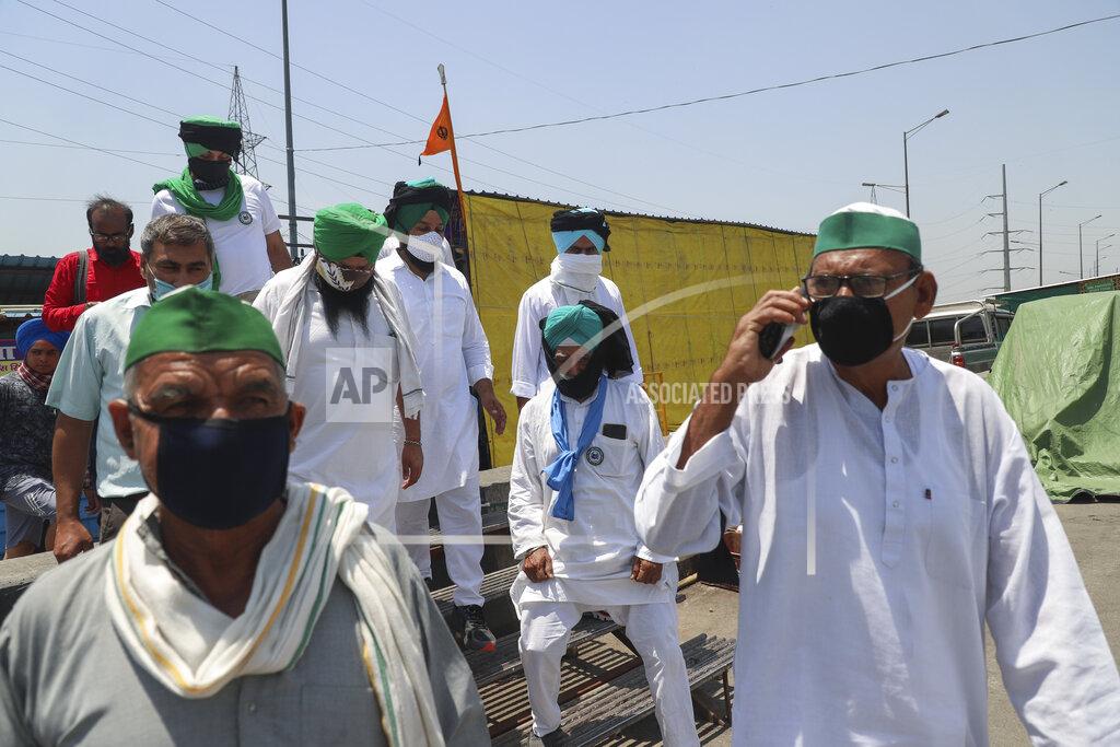 Amit Sharma Farmers wear black bands across their faces as they gather for a protest in Ghazipur, outskirts of New Delhi, India, Wednesday, May 26, 2021.Farmers are marking 6 months of their agitation against the new agricultural laws they say will leave them poorer and at the mercy of big corporations. The government has billed the laws as necessary to modernize agriculture. Multiple rounds of talks between the government and farmers have failed to end the stalemate. (AP Photo/Amit Sharma)