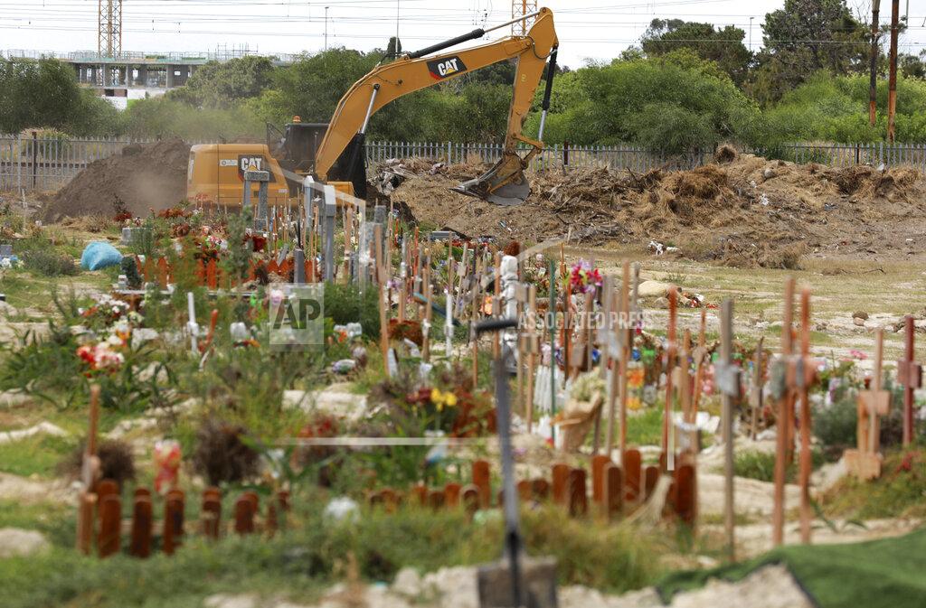 Land is excavated to make way for more burial space in the Maitland cemetery in Cape Town, South Africa, Tuesday, Jan. 19, 2021. The City of Cape Town is working closely with the Muslim Judicial Council to increase burial capacity as COVID-19 claims more lives in a second surge of the pandemic. (AP Photo/Nardus Engelbrecht)