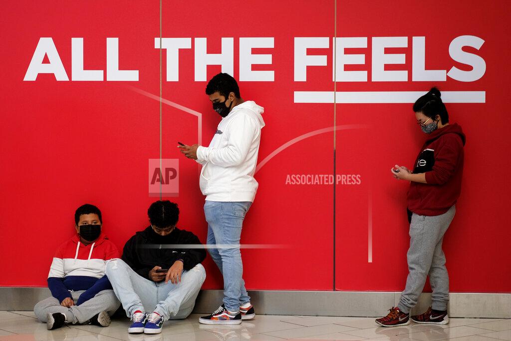 Ringo H.w. Chiu Black Friday shoppers wearing face masks wait in line to enter a store at the Glendale Galleria in Glendale, Calif., Friday, Nov. 27, 2020. (AP Photo/Ringo H.W. Chiu)
