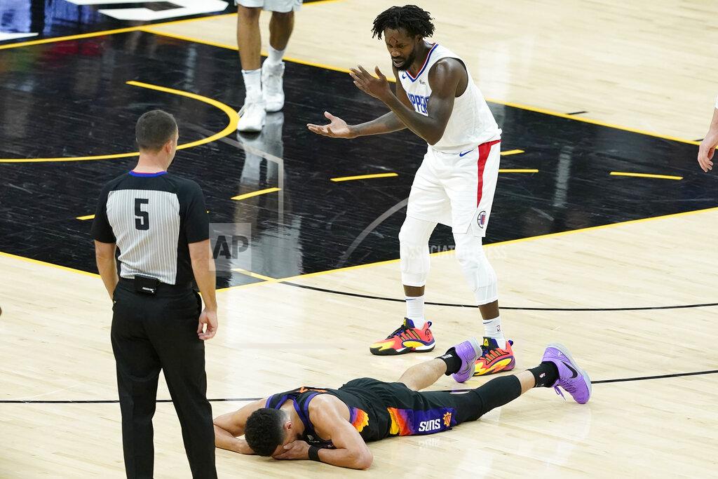 Matt York Los Angeles Clippers guard Patrick Beverley, top, reacts after being called for a foul on Phoenix Suns guard Devin Booker, bottom, during the second half of Game 2 of the NBA basketball Western Conference Finals, Tuesday, June 22, 2021, in Phoenix. (AP Photo/Matt York)
