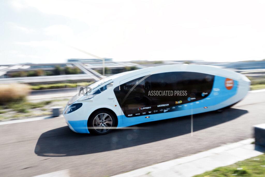 Thibault Camus The solar-powered vehicle drives in a closed road, in Guyancourt, south of Paris, Friday Sept. 24, 2021. A group of Dutch students has reimagined van life and is hitting the road to Portugal. Just don't call their groundbreaking new solar-powered vehicle a campervan. (AP Photo/Thibault Camus)