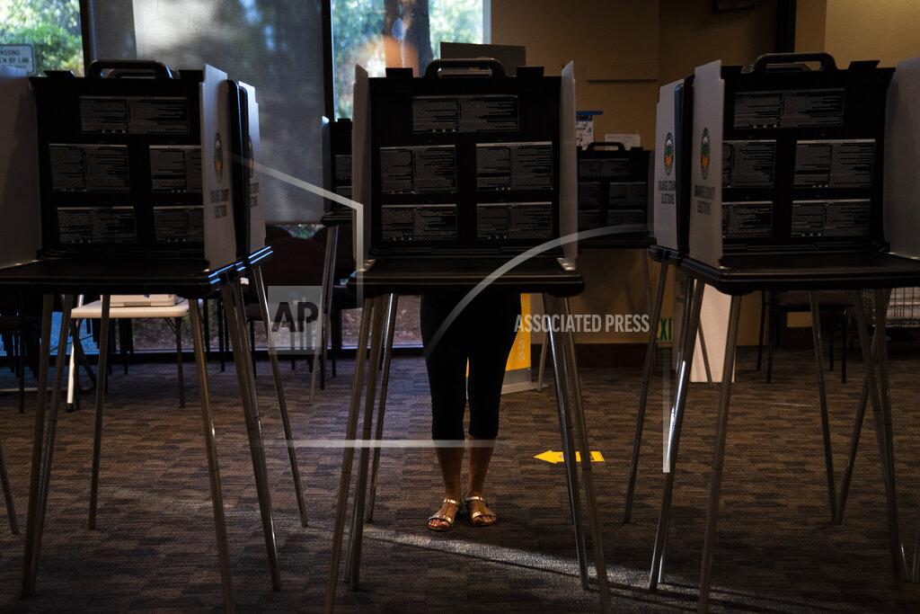 Jae C. Hong A voter casts her ballet at a vote center, Tuesday, Sept. 14, 2021, in Huntington Beach, Calif. With Gov. Gavin Newsom's fate at stake, Californians on Tuesday cast the last of the ballots that will decide whether he continues to lead them or if the nation's most populous state veers in a more conservative direction amid anger over his actions during the COVID-19 pandemic. (AP Photo/Jae C. Hong)