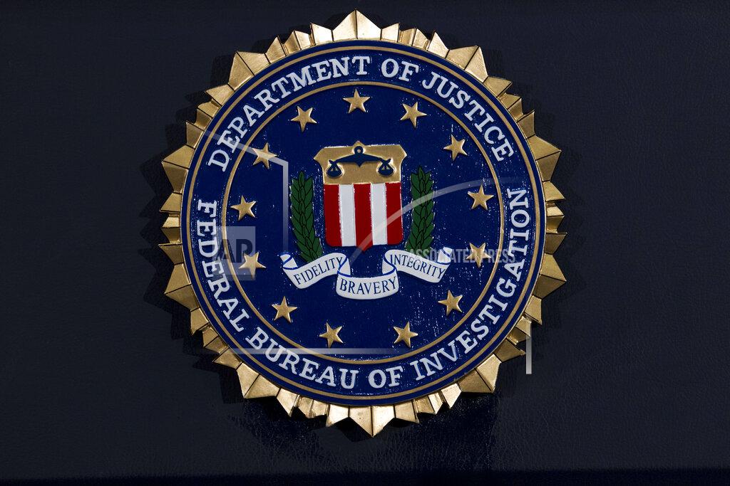 FILE - This Thursday, June 14, 2018, file photo, shows the FBI seal at a news conference at FBI headquarters in Washington. In an alert Wednesday, Oct. 28, 2020, the FBI and other federal agencies warned that cybercriminals are unleashing a wave of data-scrambling extortion attempts against the U.S. healthcare system that could lock up their information systems just as nationwide cases of COVID-19 are spiking. (AP Photo/Jose Luis Magana, File)
