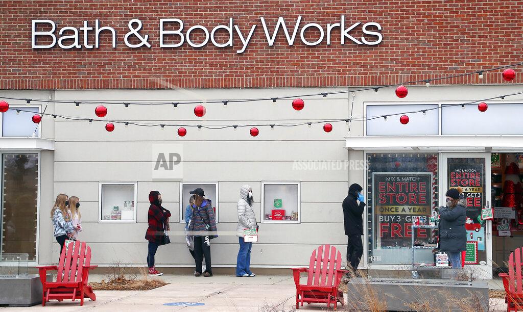 Brian Hill A socially distanced line of customers wait to shop at Bath & Body Works during Black Friday shopping outdoors at Deer Park Town Center Friday, Nov. 27, 2020, in Deer Park, Ill. (Brian Hill/Daily Herald via AP)