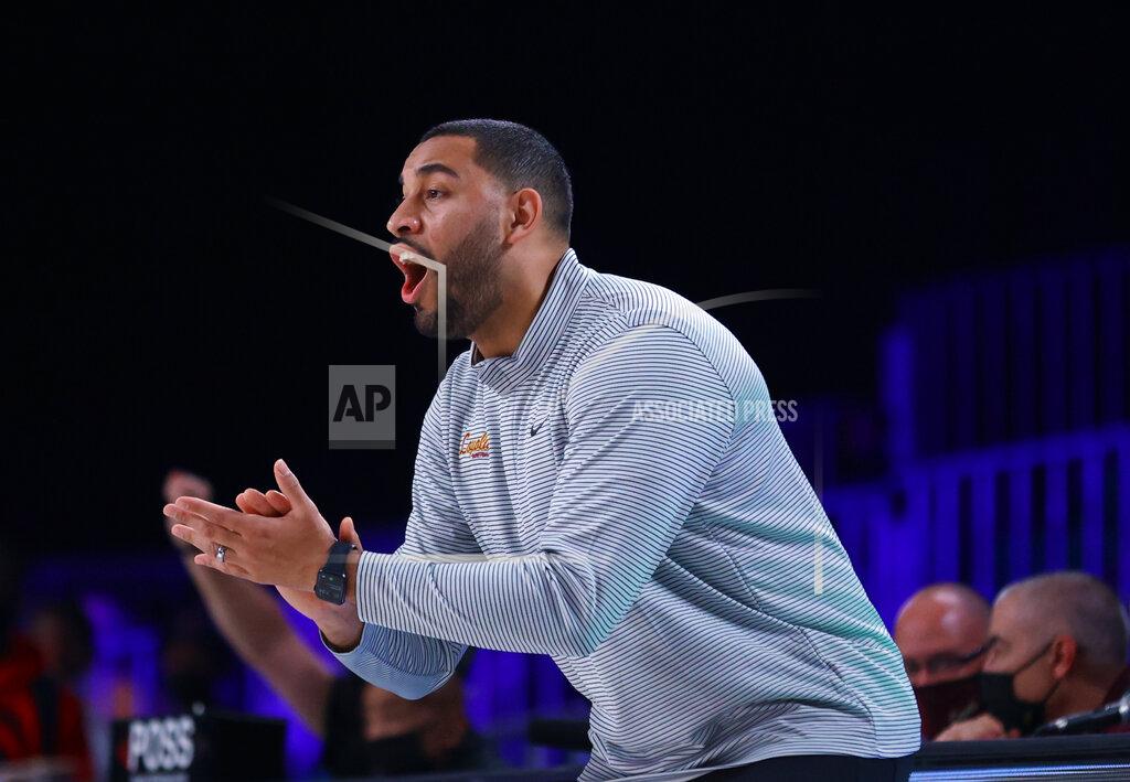 Tim Aylen In a photo provided by Bahamas Visual Services, Loyola Chicago coach Drew Valentine applauds during the team's NCAA college basketball game against Arizona State at Paradise Island, Bahamas, Friday, Nov. 26, 2021. (Tim Aylen/Bahamas Visual Services via AP)