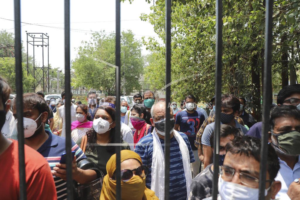 Amit Sharma FILE - In this May 10, 2021, file photo, people waiting to get vaccinated against the coronavirus stand outside the closed gates of a hospital in Ghaziabad, outskirts of New Delhi, India. The disparities of the coronavirus pandemic were already stark in India, where access to health care is as stratified and unequal as other parts of its society. Now, the divide along the lines of wealth and technology are further widening that chasm, and many people are falling through the gaps as vaccines remain inaccessible to millions. (AP Photo/Amit Sharma, File)