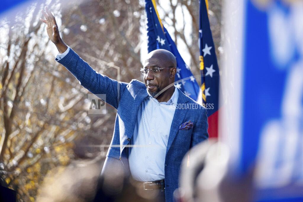 Ben Gray Democratic U.S. Senate challenger the Rev. Raphael Warnock during a rally, Monday, Dec. 21, 2020 in Columbus, Ga. with Vice President-Elect Kamala Harris and fellow Democratic U.S. Senate challenger Jon Ossoff. (AP Photo/Ben Gray)
