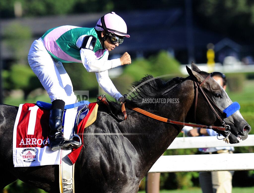 Hans Pennink FILE - In this Aug. 27, 2016, file photo, jockey Mike Smith celebrates aboard Arrogate after winning the Travers Stakes horse race at Saratoga Race Course in Saratoga Springs, N.Y. Arrogate, winner of the 2016 Breeders’ Cup Classic and the champion 3-year-old male that year on his way to becoming North America’s all-time leading money earner, has died. He was seven. Juddmonte Farms said Arrogate was euthanized Tuesday, June 2, 2020, after becoming ill.(AP Photo/Hans Pennink, File)
